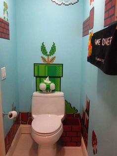 a toilet in a bathroom decorated with mario bros decorations