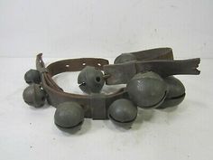 an old pair of leather bracelets with metal balls on the ends and two clasps