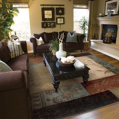 a living room with two couches and a coffee table in front of a fireplace