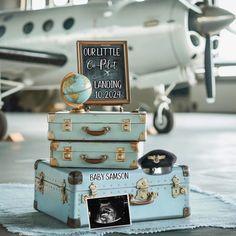 three suitcases stacked on top of each other in front of an airplane