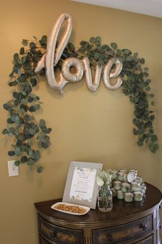 the table is decorated with balloons and flowers