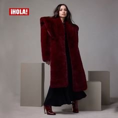 a woman in a long red fur coat