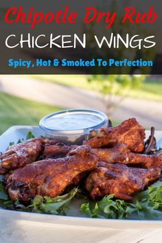 chicken wings on a plate with dipping sauce