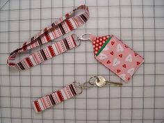 two lanyards with red and white designs on them, one has a pink cup