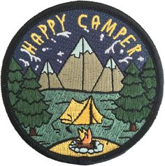 a patch with the words happy camper on it and a tent in the background