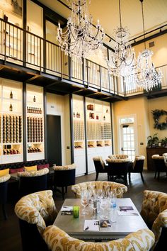 an elegant dining room with chandelier and seating