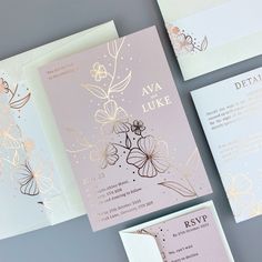 the wedding stationery is laid out on top of each other