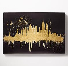 a black and gold cityscape with white paint splattered on it