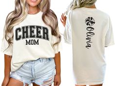 Celebrate your cheerleader with our varsity-style "cheer mom" shirt, featuring bold letters on the front. The back showcases a pom pom and is personalized with your cheerleader's name, making it the perfect gift for any proud cheer mom or mama passionate about cheerleading. COMFORT COLORS 1717 SHIRT: Unisex 100% US cotton - ethically grown and harvested Pre-Shrunk Fabric Relaxed Fit - Size up for a trendy oversized look Seamless Sides Double Needle Stitching Garment-dyed  CARE INSTRUCTIONS: Wash Cheer Mom Era Shirt, Cheer Shirt Ideas Design, Cheer Fan Shirts, Cheer Family Shirts, Senior Cheer Mom Shirts Design, Varsity Short Sleeve Tops For Cheerleading, Varsity Style Short Sleeve Cheerleading T-shirt, Varsity White Tops For Cheerleading, Varsity Style Short Sleeve Tops For Cheerleading