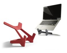 two laptops are connected to each other on the same stand, one is holding a lap top