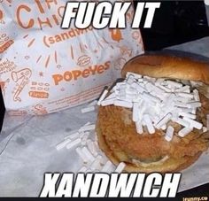 a chicken sandwich with shredded cheese on it