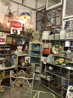 a room filled with lots of different types of dishes and cups on shelves next to each other