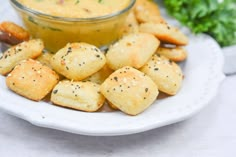 small crackers on a plate with dipping sauce