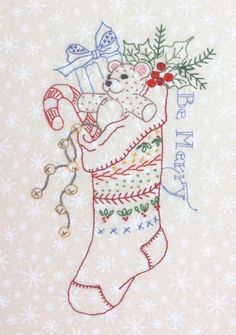 a christmas stocking with a teddy bear holding a candy cane in it's mouth