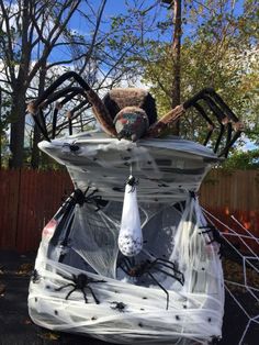 a stuffed spider sitting on top of a car