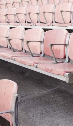 empty pink seats in an empty stadium