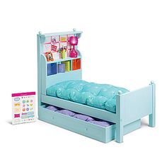 a toy bed with drawers and toys on the bottom shelf in front of it's headboard