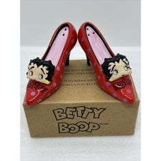 Add Some Flair To Your Kitchen With These Fun And Colorful Betty Boop High Heeled Shoe Salt & Pepper Shakers! Featuring A Cute Pink Polka Dot Design With Betty Boop's Face On The Front, These Ceramic Shakers Are A Must-Have For Any Betty Boop Fan. Perfect For All Occasions, These Shakers Are Great For Adding A Touch Of Personality To Your Dining Table. With A Height Of 2 Inches And A Length Of 4.5 Inches, These Shakers Are A Great Size For Everyday Use. The Set Includes Two Shakers, Each With A Betty Boop Jewelry, Original Betty Boop, Red Lipstick Kisses, Dog Kisses, Hearts And Roses, Face Mug, Polka Dot Design, Dot Design, Pink Polka Dots