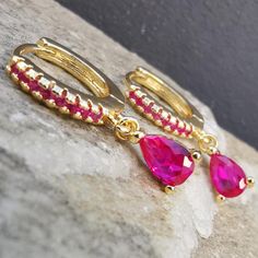 Material : 18K Gold Filled Stainless Steel Stone : Magenta 5A Cubic Zirconia Hoop Inner Size : 8.1 mm / 0.32 in. Total Length : 20 mm / 0.83 in. Bar Thickness : 0.8 mm / 0.03 in. A stunning Magenta Earrings Pair for every occasion! Combine it with your gold collection and other magenta pieces or even mix it with green and blue for the ultimate exotic ear curation! Crafted with Gold Filled Stainless Steel to secure durability so you can wear it day and night!Selling as pair. Make it yours Now! Di Magenta Earrings, Ear Curation, Droplet Earrings, Ear Piercing, Earring Jewelry, Gold Collection, Ear Piercings, Favorite Jewelry, Jewelry Earrings Dangle