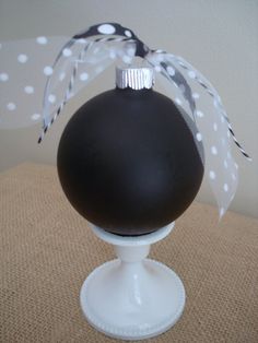 a black and white christmas ornament sitting on top of a table