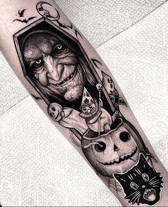 a black and white tattoo with an image of a man's face on the arm