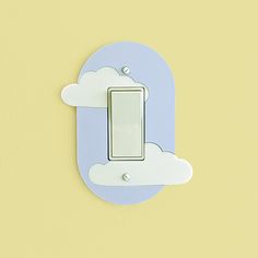 a blue and white light switch sitting on top of a yellow wall next to a cloud