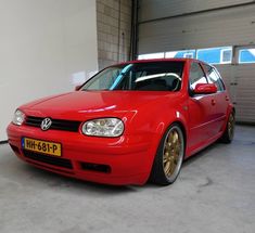 a red car is parked in a garage