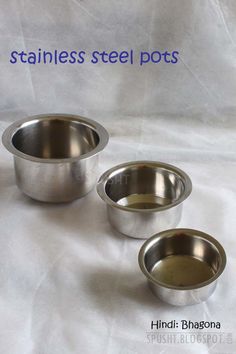 three stainless steel pots sitting next to each other on a white sheet with the words stainless steel pots above them