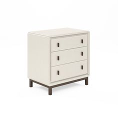 a white dresser with three drawers on it