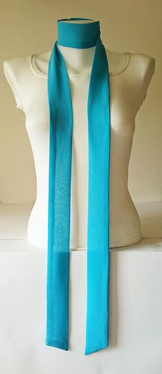 This turquoise skinny scarf is made of an beautiful crepe chiffon fabric. It is sewn with a double layer, no raw edges or open seams. It has angled ends. You can wrap skinny scarf around your neck in one of many different ways. It can be use as a headband and belt also. Details: ♥ The skinny scarf has been sewn in double layer, no raw edges or open seams. ♥ Material: Crepe chiffon fabric  ♥ Color: Turquoise ♥ Measurements; ~ Length: 80 inches  ~ Width: 2 inches  ♥ Care: Hand wash cold and lay fl Scarf Neck Tie, Narrow Scarf, Chiffon Bow, Tie Fashion, Scarf Neck, Scarf Top, Color Turquoise, White Silk, Chiffon Fabric