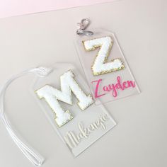 two tags with the letters z and m on them, one has a string attached to it