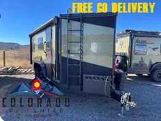 a trailer that is sitting in the gravel with an advertisement for colorado camper trailers