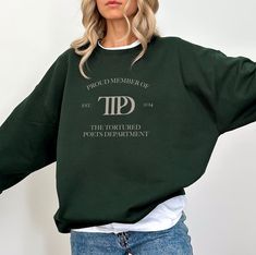 Celebrate Taylor's new album The Tortured Poets Department in this soft, cozy crewneck sweatshirt. It has the The Tortured Poets Department logo on the front. Details - Original artwork. - Advanced DTF Printing Technology and superior-grade inks for highest quality print. - A classic sweatshirt with crew neck. - Pre-shrunk 1x1 athletic rib-knit collar with spandex - Air-jet spun yarn with a soft feel and reduced pilling - Double-needle stitched collar, shoulders, armholes, cuffs, and hem - Quart Aunt Sweater, Aunt Sweatshirt, Mrs Hudson, Aunt Shirts, Bow Shirts, Merry Christmas Shirts, Moms Club, Mother Birthday Gifts