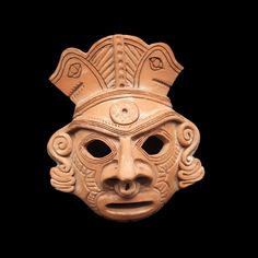 an ancient mask is shown against a black background