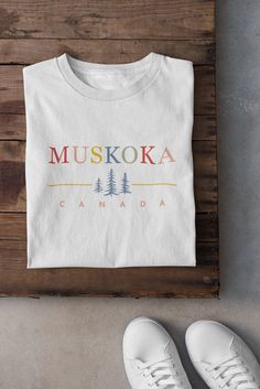 Muskoka, Canada print on a super soft Bella + Canvas t-shirt. This shirt is perfect for cottage weekends, hiking, camping, and having a couple s'mores by the campfire!  100% cotton, unisex sizing. See photos for a full size chart. Machine wash cold, hang dry. The print is a soft, high-quality screen print which will not fade or peel in the wash. Designed and printed in Canada.  Eco-friendly: uses 7x less water than traditional t-shirts. 100% sweatshop free and Platinum WRAP Certified. FREE SHIPP Cotton T-shirt With Letter Print For Camping, Cotton T-shirt With Letter Print For Outdoor Activities, Cotton T-shirt With Text Print For Camping, Outdoor Cotton T-shirt With Custom Print, White Cotton T-shirt For Camping, Muskoka Canada, S Mores, Campfire, Retro Inspired