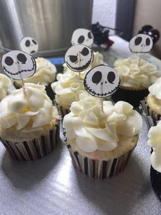 cupcakes decorated with white frosting and skulls