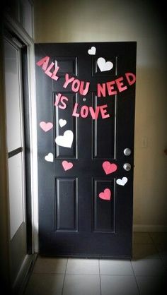 a door decorated with hearts and the words all you need is love