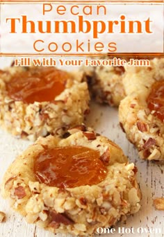 Pecan thumbprint cookies with apricot jam on a white board. Thumbprint Cookies With Jam, Pecan Thumbprint Cookies, Jam Thumbprints, Cookies Thumbprint, Cookies With Jam, Spritz Cookie, Raspberry Thumbprint Cookies, Jam Thumbprint Cookies, Hot Chocolate Fudge