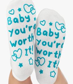 the feet of a person wearing white socks with blue writing on them that says, baby you're worth it