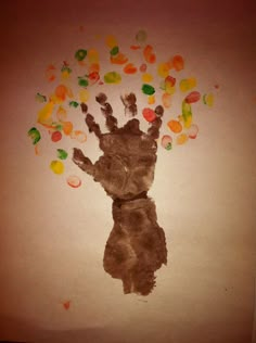 a child's hand with gummy bears coming out of it and falling into the air