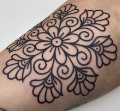 a black and white tattoo design on the arm