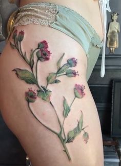 a woman's thigh with flowers painted on it