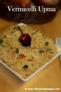 a white bowl filled with food on top of a wooden table