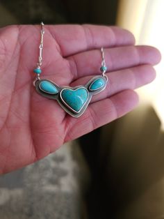 Small statement.  This is created with 925 sterling silver.  The focal stone is a gorgeous Campitos turquoise heart.  The accent turquoise are Kingman.  A simple setting.  Keeping the focal on the awesome stones.  A small but strong chain has been added.  I have cold connected the pendant and clasp, using beautiful Pilot Mountain rondels.  Giving the one-of-a-kind personal touch.  A gorgeous everyday wear.  For years to come.  18" length. See pictures for size reference.  Ready to ship. Heart-shaped Sterling Silver Turquoise Necklace, Turquoise Heart Pendant Jewelry With Natural Stones, Turquoise Sterling Silver Heart Pendant Necklace, Turquoise Heart Pendant Necklace In Sterling Silver, One Of A Kind Sterling Silver Heart Necklace, Heart-shaped Turquoise Gemstone Necklace, One Of A Kind Heart-shaped Sterling Silver Necklace, Sterling Silver Turquoise Necklace With Heart Charm, Unique Turquoise Jewelry With Heart Charm