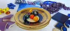 a table topped with lots of different types of beads and other items on top of it