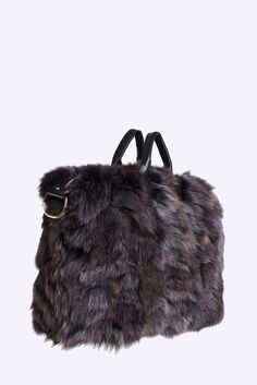 This large duffle is made in soft upcycled long hair racoon with leather trim, polyester lining and comes with a removable leather shoulder strap.Color and style of fur may vary slightly due to variations in the upcycling process. This item is made to order. Please allow 10 – 20 business days for International delivery. Luxury Faux Fur Shoulder Bag, Luxury Faux Fur Shoulder Bag With Fur Lining, Luxury Sheepskin Bags With Faux Fur Lining, Luxury Winter Travel Shoulder Bag, Luxury Travel Bags For Winter, Luxury Faux Fur Shoulder Bag For Everyday Use, Luxury Bags With Faux Fur Lining For Winter, Luxury Faux Fur Bag For Everyday Use, Luxury Faux Fur Bags For Everyday Use