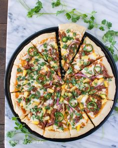 a pizza sitting on top of a pan covered in cheese and veggie toppings