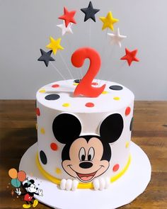 a mickey mouse birthday cake with stars on top and the number two in the middle