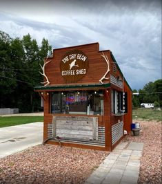 an old fashioned coffee shop on the side of a road