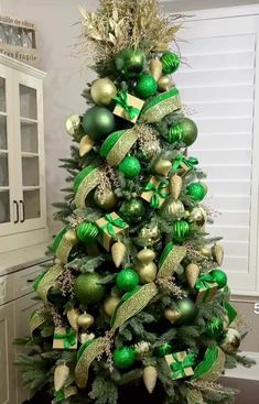 a christmas tree with green and gold ornaments